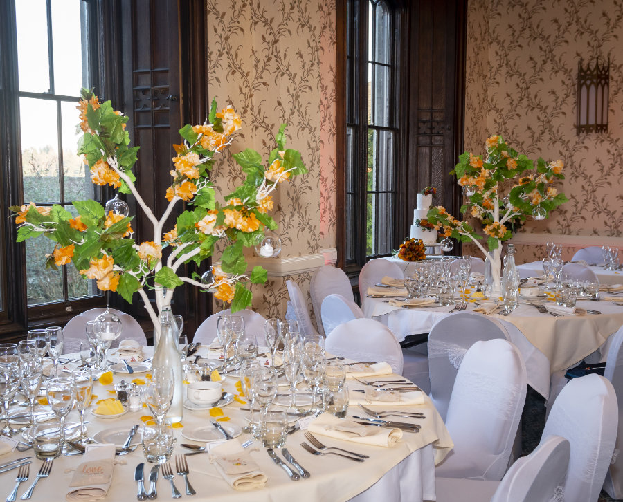 Orange blossom on white trees centrepieces