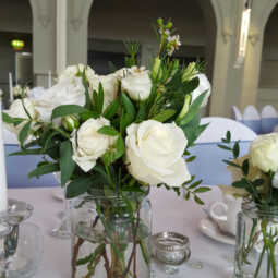 wedding centerpiece with ivory flowers in jars