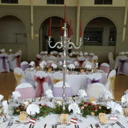 wedding table decorated with candelabra and floral and foliage garlands