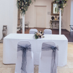 white wooden wedding arch with floral arrangements at Fazeley Studios Birmingham