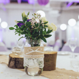 rustic centerpiece with jars logs flowers and candles
