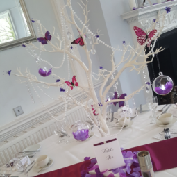 white tree wedding centerpiece with purple butterfly and petal decor