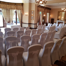 wedding ceremony room with white lace chair sashes