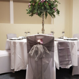 silver grey chair hood with floral detail in bow
