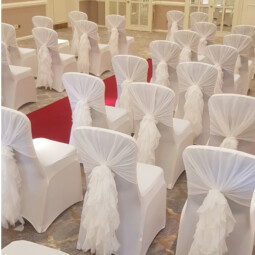 white ruffle hoods and chair covers