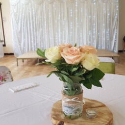 jar centrepiece with pink and ivory roses