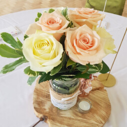 jar centrepiece with roses and foliage