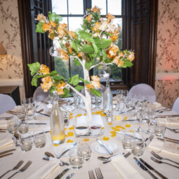 white tree centrepiece with orange blossom and glass baubles