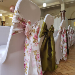 top table chair decor in floral and olive green sashes