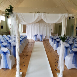 wedding ceremony decor with arch, backdrop and aisle runner