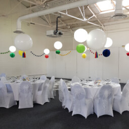 white balloon centrepieces and hanging decor in wedding breakfast room
