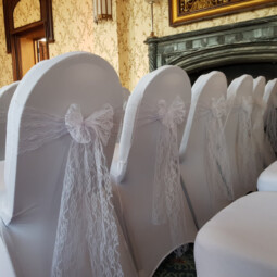 white lace sashes with white chair covers