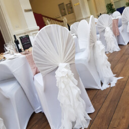 wedding chairs with white ruffle hoods